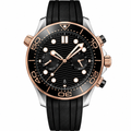 Diver chronograph watch with black dial, black rubber strap, and rose gold-tone case on white background